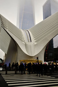 People walking on modern buildings in city