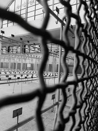 Close-up of basketball hoop seen through chainlink fence