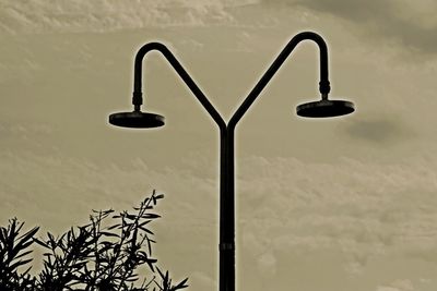 Low angle view of street light against sky