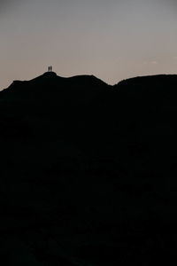 Silhouette mountain against clear sky