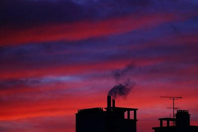 Smoke emitting from chimney against sky