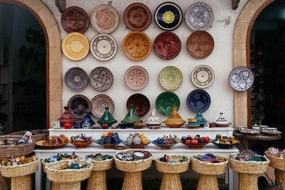 Colourful plates on the wall and an abundance of tajine pots on display, essaouira, morocco.