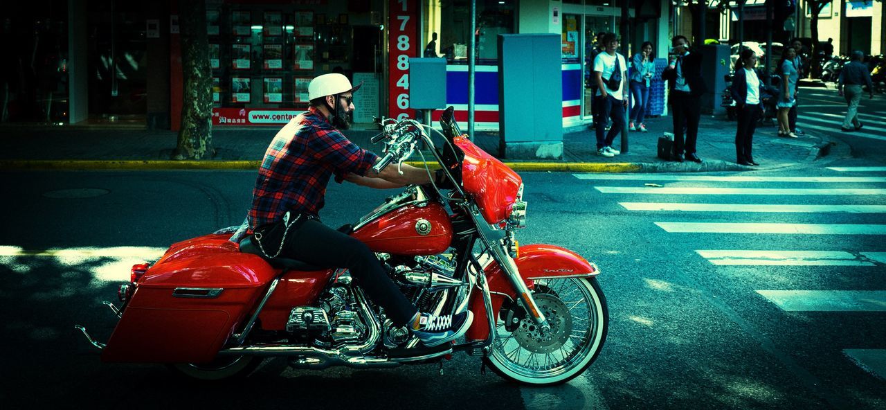 motorcycle, transportation, street, real people, men, mode of transport, land vehicle, built structure, outdoors, city, crash helmet, building exterior, helmet, riding, architecture, day, road, full length, scooter, sports helmet, headwear, one person, biker, adult, people