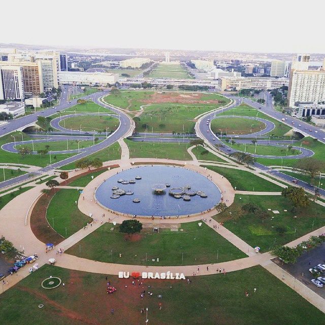 architecture, building exterior, built structure, high angle view, city, cityscape, green color, tree, grass, travel destinations, day, tourism, capital cities, famous place, city life, outdoors, residential building, international landmark, travel, incidental people