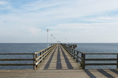 Pier over sea against sky