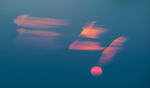 Low angle view of moon in sky during sunset