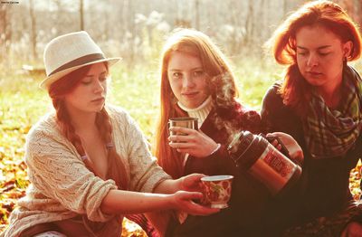 Young woman drinking outdoors