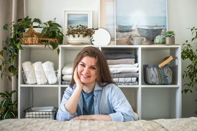 Portrait of young woman sitting at home