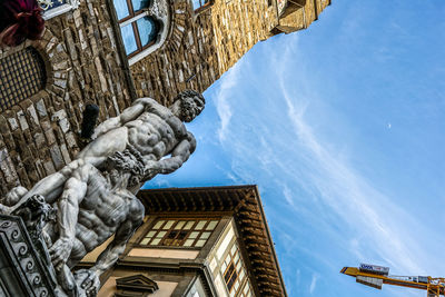 Low angle view of hercules and cacus at palazzo vecchio against sky