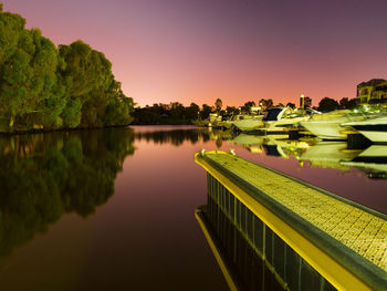 Scenic view of lake against sky at night