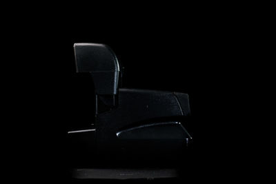 Close-up of empty seat against black background