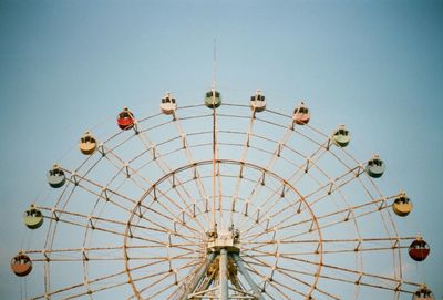 Low angle view of ferris wheel against clear sky