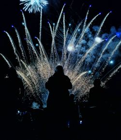 Group of people watching fire crackers at night