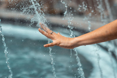 Midsection of man splashing water