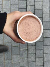 Low section of person holding coffee cup