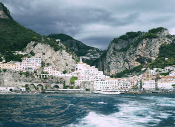 Scenic view of sea and buildings against sky