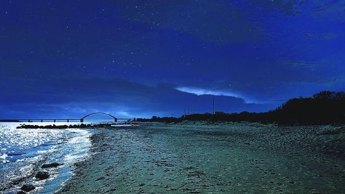 Illuminated landscape against clear sky