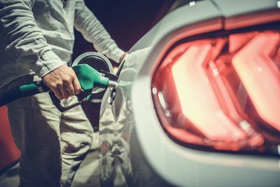 Midsection of man holding car