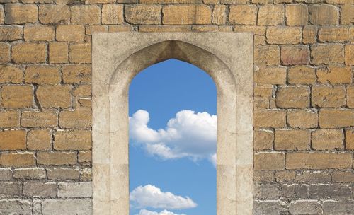 Arch window against brick wall