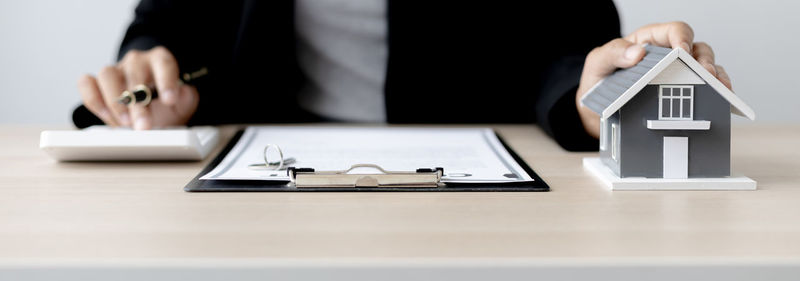 Midsection of man using laptop on table