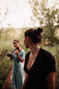 Young woman with arms raised standing on land