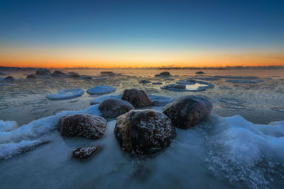 Scenic view of sea against clear sky during winter