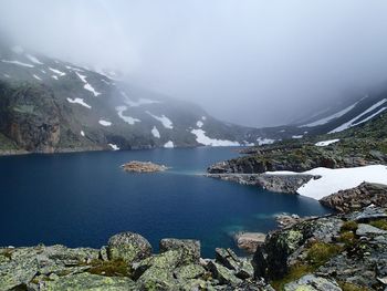 Scenic view of lake and mountains against sky