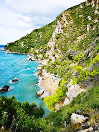 Scenic view of sea and mountains against sky