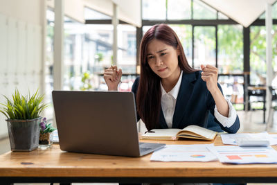 Stressed businesswoman working at office