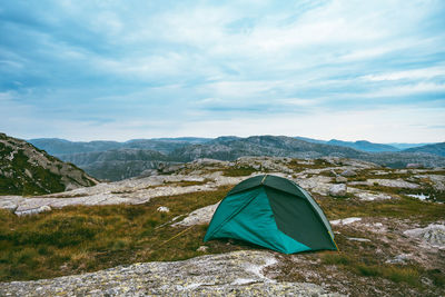 Scenic view of tent on mountain against sky