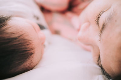 Close-up of mother and son on bed