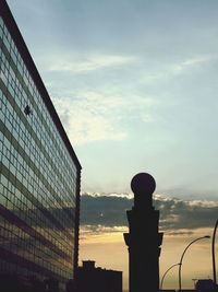 Low angle view of silhouette buildings against sky at sunset