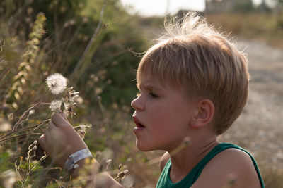 Portrait of girl holding plant