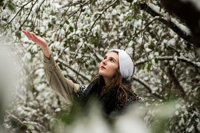 Portrait of young woman in park during winter