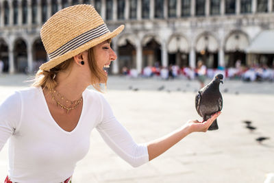 Close-up of woman wearing hat against blurred background