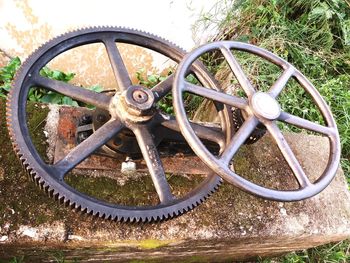 High angle view of rusty wheel on field