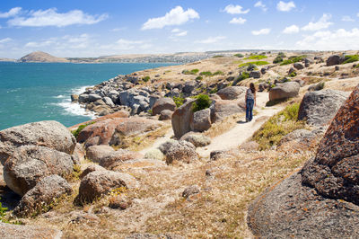 Panoramic view of rocks on beach against sky