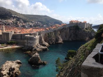 Scenic view of sea and buildings against sky and city walls dubrovnik 