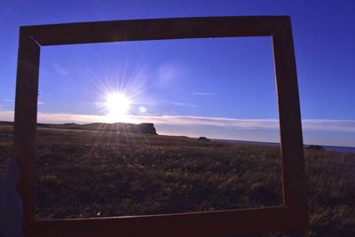 Scenic view of field against sky during sunset