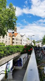 Canal amidst buildings in city against sky