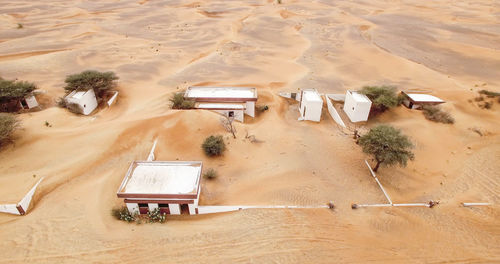 High angle view of tire tracks on sand dune