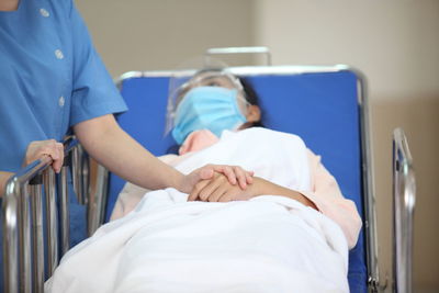 Midsection of woman lying on bed