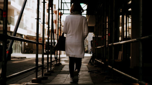 Rear view of woman walking on street