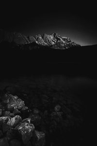 Scenic view of lake and rocks against sky