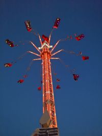 Low angle view of illuminated ferris wheel against sky