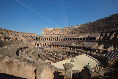Historic coliseum against blue sky
