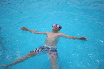 Close-up of boy floating in swimming pool