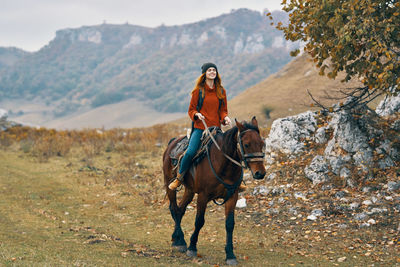 Young woman riding horse