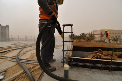 Man working at construction site against sky