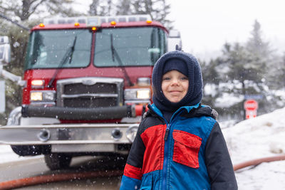 Portrait of smiling boy standing on road